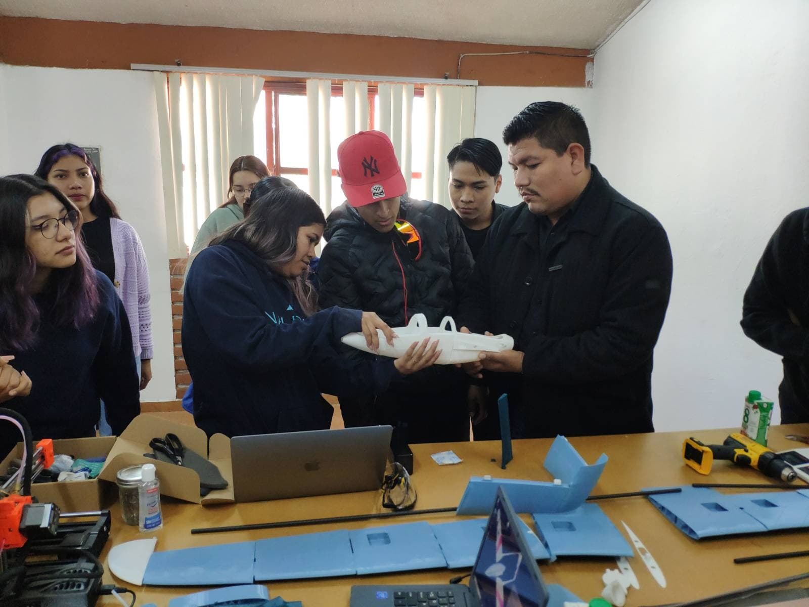 Students collaborating on drone assembly